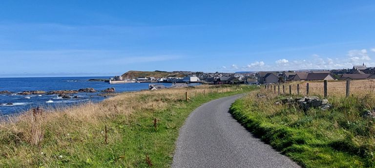 Whitehills. 

Route 1 turned left off a speedy road,  DOWN a hill to Whitehills. I wondered why.