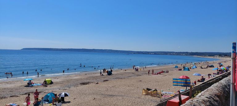 People enjoying themselves, with Penzance in the background