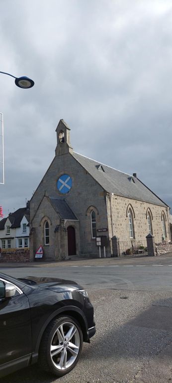 A young German couple whom I met at the Park Guesthouse, I think when checking out and saw again as we cycled back through and out of town, kindly donated.  Their generosity touched me.  1899 St Andrew's CofS church directly opposte the Park Guesthouse, Aviemore.   Aviemore's 4000 year old Ring Cairn and Stone Circle was 0.3 mile up our route on the right. There are two other ancient stone circles near Aviemore: one 4 miles south west; the other, about a mile north of our route.  About the church:  http://www.standrews-aviemore.org.uk  About the clava cairns of Aviemore: https://en.wikipedia.org/wiki/Clava_cairns_of_Aviemore