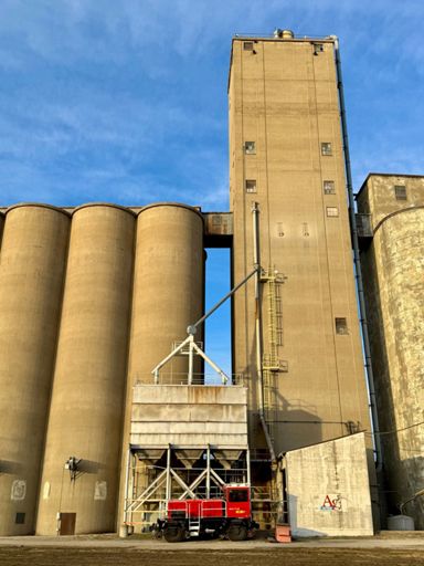 This little red locomotive with rubber street wheels and steel train wheels is cute.