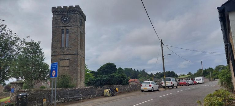 Approaching Braco via the B8033. The tower, with a clock paid for by public subscription, is all that remains of Braco Free Church, opened 1845 and struck by lightning sometime thereafter after which the rest was demolished for H&S.  https://ardochparishchurch.org/church-history/