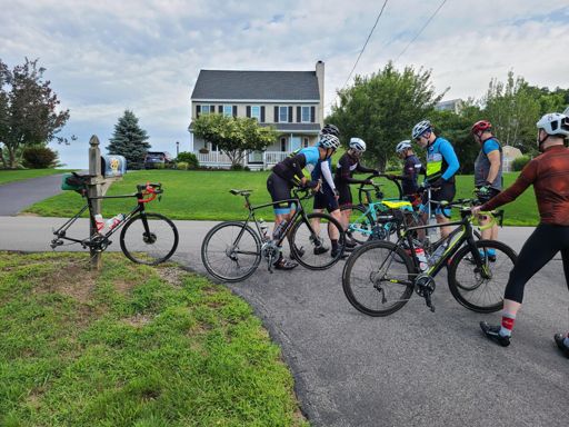 How many cyclists does it take to change a flat tire?  At least 8, several to change the tire, another few to make sure they are doing it right, one to hold the bike of the one that is taking a picture.  We shouldn't forget the mailbox that is holding the bike with a flat.