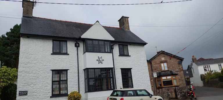 1907 Grade II listed Newton Lodge in Shirenewton in Arts and Crafts Movement style. 

https://cadwpublic-api.azurewebsites.net/reports/listedbuilding/FullReport?lang=en\u0026id=24576 

Not retrieved explanation for the "L".