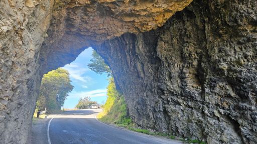 The road goes under a pair of rocks leaning on each other. One day...!