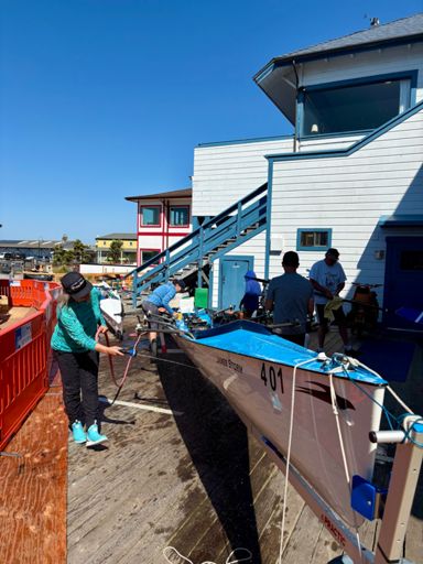 Rinsing salt water off the boats before putting them away