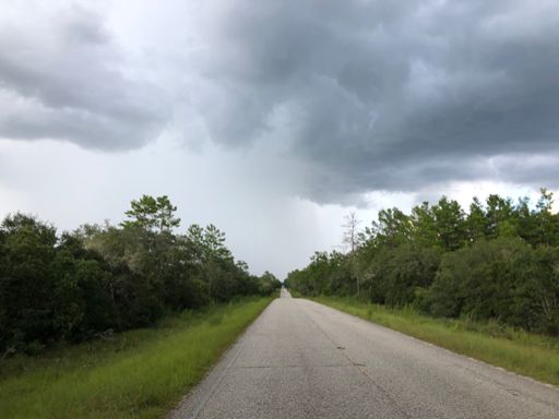 Looking back at the rain storm I rode through and out of back into dry roads. The thunderstorm outflow from this made for an awesome tailwind.