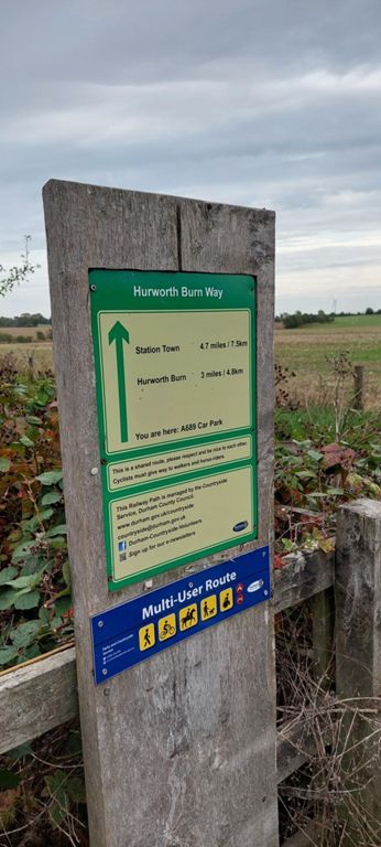 This sign has the Hurworth Burn Way as being 4.7 miles long from Station Town to just north of the A689; various bodies differ in their perspective of the location and length of HBW and Castle Eden Walkway (CEW) – see this photo in the Google Photo album for more on this.  Hurworth Burn Way is part of CEW, itself part of NCN Route 1, from the A181 in Wellfield, Wingate (west of Castle Eden) to a little north of Thorpe Thewles.   Measuring in Komoot the length of CEW according to OS Map and Open Street Map links on the GPS Cycle and Walkway Routes webpage, (rather than only the CEW length according to Komoot), it is 10.1 miles long.  OS Maps, searched separately, only has the CEW starting no further north than Station Town.   The next photo shows the Hurworth Burn Railway Path consisting of the Hurworth Burn Way and part of the Castle Eden Walkway.  Confused yet!  All these are parts of the former railway from Ryhope to Stockton, and appear to have been developed  and perhaps maintained by separate organisations, which could account for the plethora of names.
