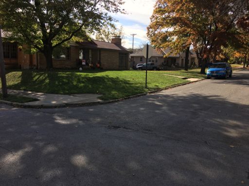 My grandparents house. This corner is where I learned how to ride a bike at 7.  I'd push myself off this curb and try to balance.  I'm getting the hang of it.