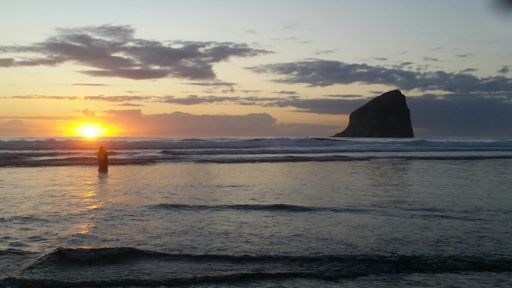 Eldest boogie boarding in a beautiful sunset.
