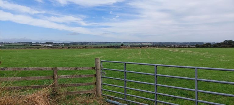 View north from Dornock, and in the distance four chimney-like structures. What are they?  More pictures as we got closer.