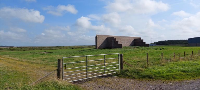 George, a farmer in Thurdistoff, explained that RAF Castletown airfield had been in the locality during WW2. Spitfires patrolling the Orkneys and Scappa Flow where the British fleet were based flew from it. This was a target for practice.  OS Maps show that the runways had been in the field opposite the end of the road we are on, for a few hundred yards both ways.  https://en.wikipedia.org/wiki/RAF_Castletown