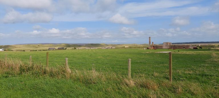 The building with the chimney was a decontamination facility in case of chemical warfare. It was never used in anger.