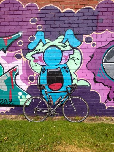 Just a bike against a colourful wall.