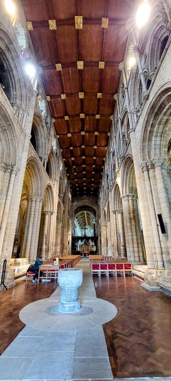 From the entrance towards the altar, with Norman font, beloved to date from 1100s.  https://www.selbyabbey.org.uk/top-10-things-to-see/