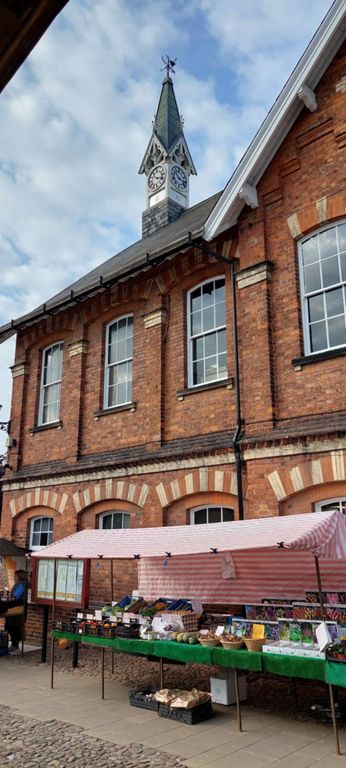 Historic England's interactive map of Easingwold's market place with links to entries for historic structures/buildings: https://historicengland.org.uk/listing/the-list/map-search?clearresults=true
Being the 3rd Wednesday of the month, this was the farmer's market, against the backdrop of the Market House, built in 1864.  The weekly market is on Fridays.
This link is to the 1923 entry for Easingwold in BHO: British History Online, hence the description of the Market House as "modern": https://www.british-history.ac.uk/vch/yorks/north/vol2/pp128-134