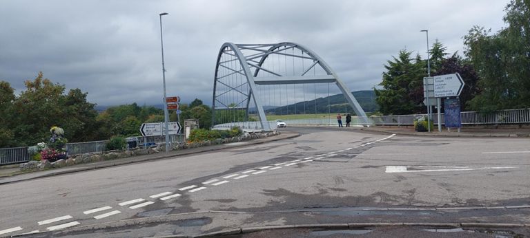 The 1973 third Bonar Bridge seen from the convenience shop on a corner where we stopped for provisions.  Notice the NCN direction sign on its left. The revised route for Day 32 will come via the bridge, with the orange Kyle of Sutherland Hub community centre and cafe on route. Read Lorraine's blog for an account of bridge 1  and 2. https://www.sabre-roads.org.uk/wiki/index.php/Bonar_Bridge & https://www.kyleofsutherland.com