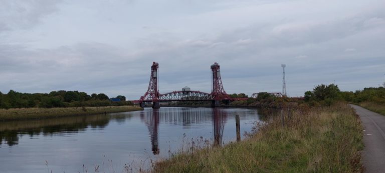 Looking down river from our route, the South Tees Cycleway:
Tees Newport Bridge, opened 1934.  Was a vertical lifting bridge; now permanently down carrying the A1032 over River Tees.  https://en.wikipedia.org/wiki/Tees_Newport_Bridge
The next photo is looking up river from the same spot.