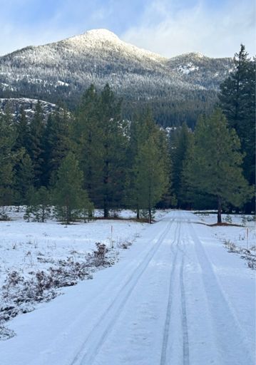 Brief patch of blue sky. Thin snow cover on flats. 