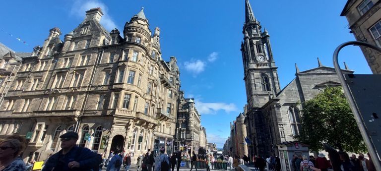 Looking north east down The Royal Mile -  High Street - with Tron Kirk Market on the right (built 1630s, closed as a church in 1952, now a market), leading down to the Scottish Parliament Building on Canongate.