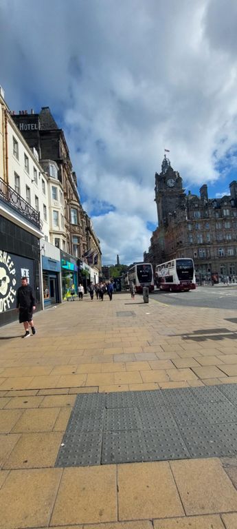 Looking north east up Princes Street with the 1902 5 star Balmoral hotel on the right and the 1816 Nelson Monument on Calton Hill beyond.  About Princess Street: https://en.wikipedia.org/wiki/Princes_Street  About The Balmoral: https://www.roccofortehotels.com/hotels-and-resorts/the-balmoral-hotel/story/  About Calton Hill, Nelson Monument, etc: https://en.wikipedia.org/wiki/Calton_Hill