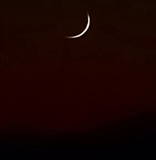 Silver moonset at sunset