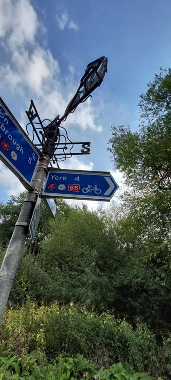 Notice the silhouette atop the sign. More to come. There's a better photo of this on the Alamy website with personal use @ £11.99 &  website use @ £31.99. Search for silhouette signs york route 65