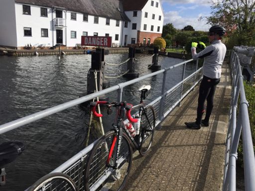 Simon (and his bike) on the weir, taking a photo of the old mill.