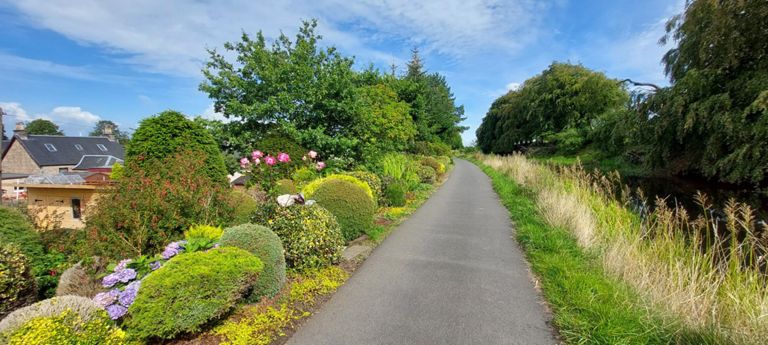 Bonnybridge.  This stretch of the canalside and a similar length behind me are tended to by David and 72yr old Sandra, carrying on this contribution to the community of someone who passed away in 2014. We got talking, and Sandra kindly donated, filled my water bottle and gave me a small pot of her strawberry jam. She is also known as Mrs Jam.