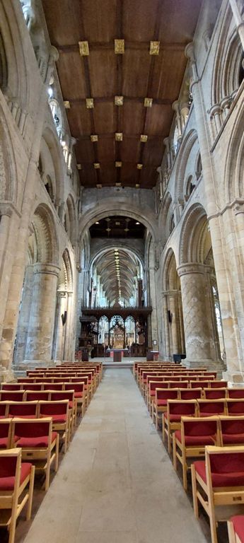 Halfway down, towards the altar