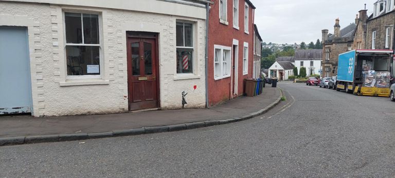 Looks like a Banksie on the shop wall.