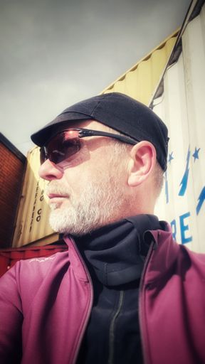 Man hides double chin with neck muff. 