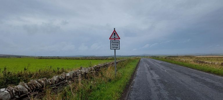New sign for me. It refers to the practice firing range established in 2014 for police protecting the nuclear facilities. It may be that mound  on the right of the road.   https://www.bbc.co.uk/news/uk-scotland-highlands-islands-29630679