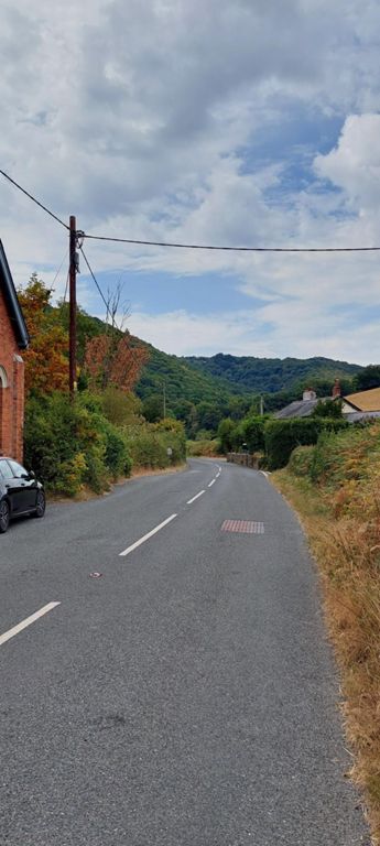 We had just descended that hill for perhaps 2 miles of downness. Super. It went on and on! Between this side the preceding photo was Moretonhampstead, where I should have communicated my location to Lorraine earlier than I did.   Communication is vital to save energy and time. We also shared our location on Google Maps, though that depended on our phones' technology and our competence!   I highly recommend the ice cream made and sold by Baskervilles Ice Cream Parlour and Coffee Shop, Moretonhampstead, which caters for cyclists. https://www.baskervilleestate.co.uk/