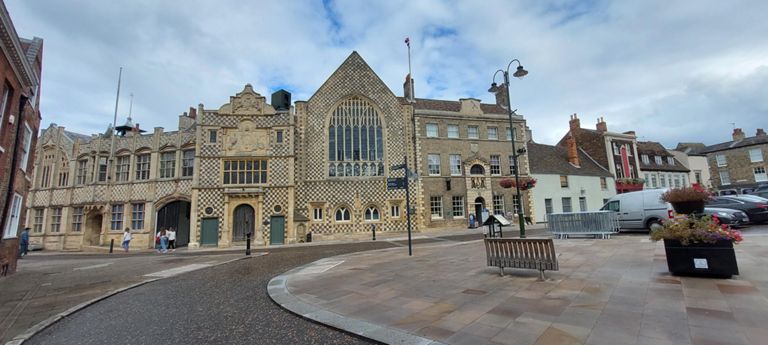 Either King's Lynn's Town Hall according to its website, or Guildhall according to Wikipedia.  Exemplar for gorgeousness! Built 1428. Opposite the Minster.  https://www.kingslynntownhall.com &  https://en.wikipedia.org/wiki/King%27s_Lynn_Guildhall