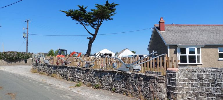 The house in Releath was built in the 1940s. The current dweller's grandfather collected this row of ploughs, some of which were used at a dairy farm on the left side of the road, though that has now been sold off in lots.