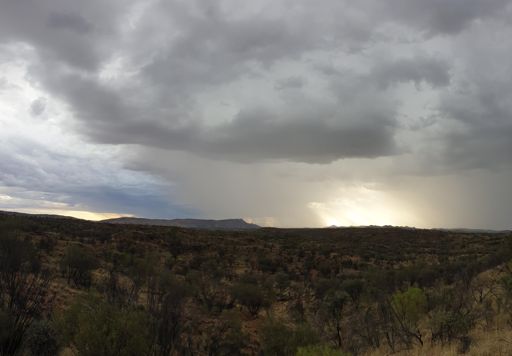 deep rumbling thunder and some rain over head.   lots of rain all around in huge storm clouds moving across the evening sky.