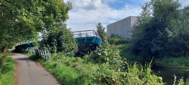 2008 horseshoe-shaped Millennium Bridge at Southbank Marina in Kirkintilloch. A gentle climb for pedestrians, allowing height for canal craft to pass under.  Cost £800,000 of out a £12m regeneration project. https://www.galvanizing.org.uk/case-studies/bridge-southbank-marina/  & https://www.galvanizing.org.uk/case-studies/bridge-southbank-marina/