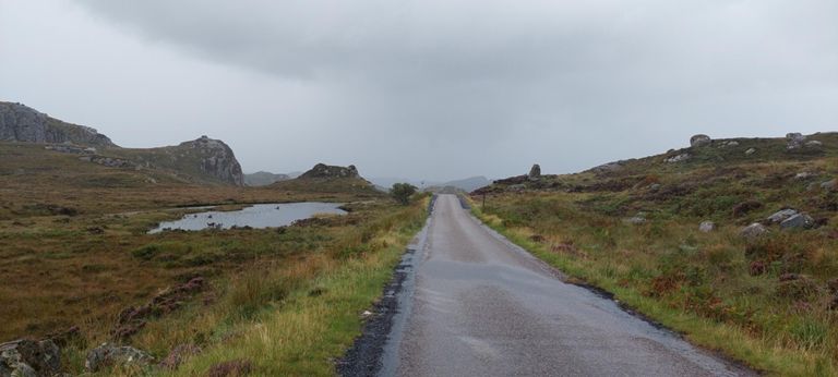 The loch is unnamed on the OS Explorer map.  This is about 0.7 mile before Rhiconich.