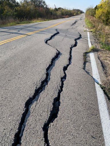 No shoulder, increasing auto traffic, and cracks like these make riding Lindell, Blue Bluff, and Bloor pretty dicey.