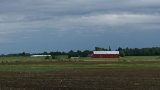 Farm under storm clouds