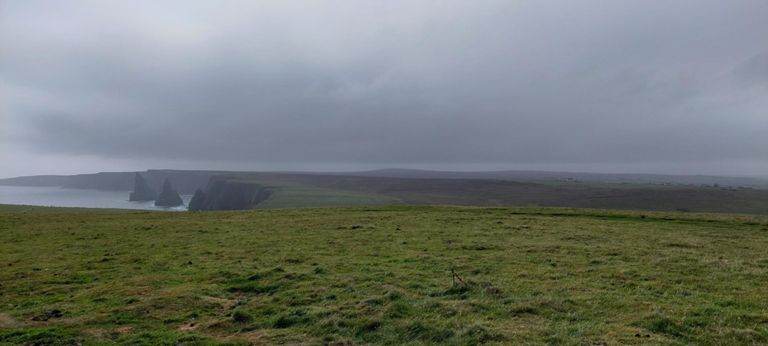 North Sea with the conical Duncansby Stacks off the coast. https://en.wikipedia.org/wiki/Stack_(geology)