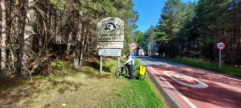 Carr-Bridge, home of the golden spurtle, world porridge making championship and the Scottish open chainsaw carving competition. 

Its parish church side-by-side with the village hall both looked attractive and like bungalows as we cycled past. Google Maps' Streetview includes a sign at the latter announcing it is "Home of the World Porridge Making Championship".  I photographed neither as we needed to get on.

https://www.goldenspurtle.com

https://www.carvecarrbridge.com